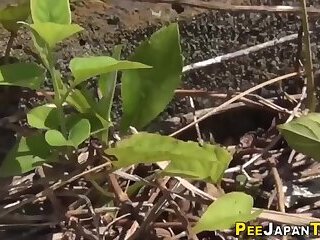 Asian students peeing outdoors